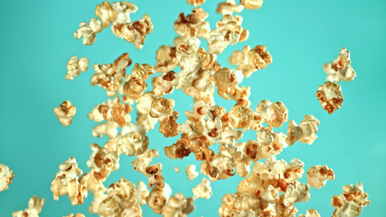 Golden Popcorn Flying Up and Falling Down in Slow Motion