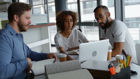 Business-colleagues-discussing-over-laptop-4k