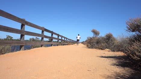 black woman riding a bike on a terrain path