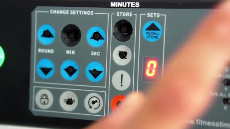 male hand pressing buttons in a sports timer