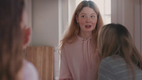 group of teenage girls eating pizza in kitchen having fun chatting together sharing gossip friends hanging out enjoying relaxing at home