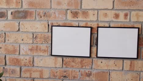 wooden frames with copy space on white background against brick wall