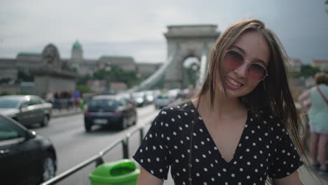 young woman smiling on a bridge in budapest