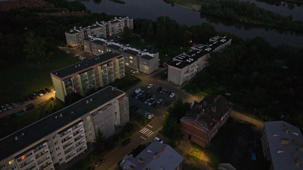 Aerial night scene showing apartment blocks and river in Nowy Dwór Mazowiecki