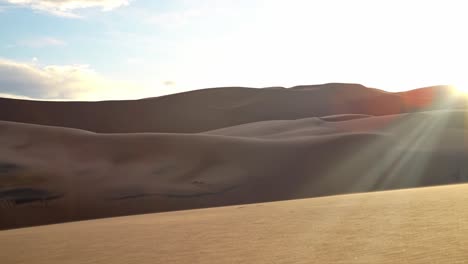 warm evening light casts long shadows on smooth sand ridges in great sand dunes national park, natural backdrop background, no people