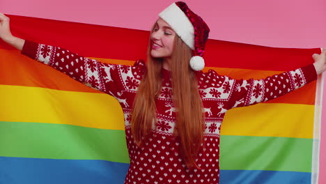 Girl-in-Christmas-sweater-posing-with-rainbow-flag-celebrate-parade-tolerance-same-sex-marriages