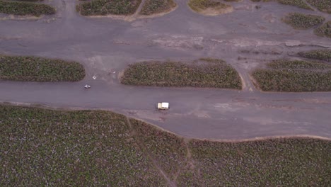 Yellow-jeep-and-motorbike-driving-on-dirt-road-at-mount-bromo-Indonesia,-aerial