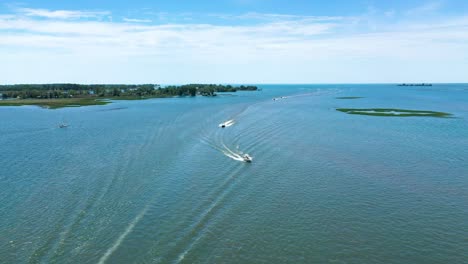 boats cruising across open water on sunny summer day