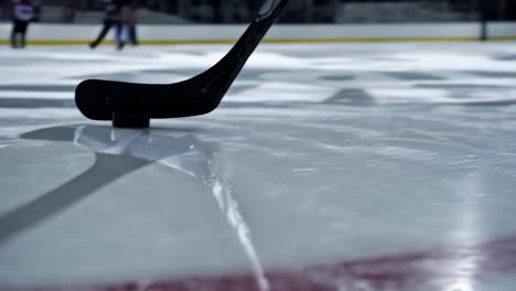 hockey stick and puck on ice