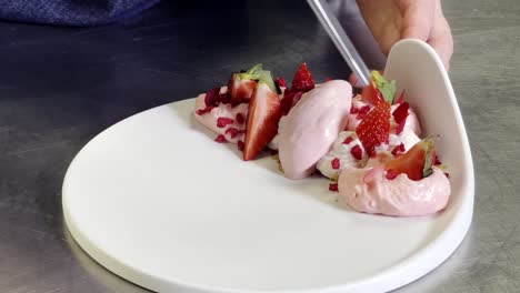 cook using tongs to ultimate strawberry dessert in galicia, spain