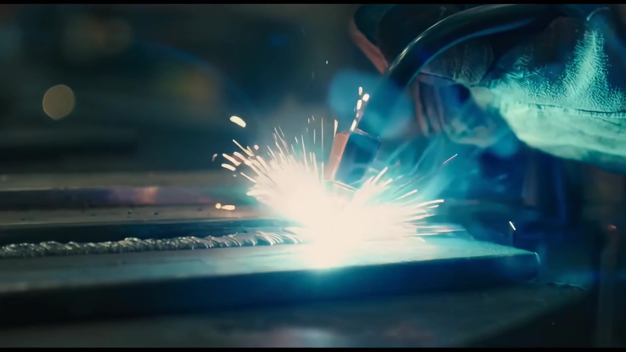Skilled Welder Working on Metal in an Industrial Factory