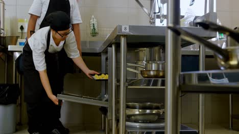 chef putting tray of cookies in oven 4k