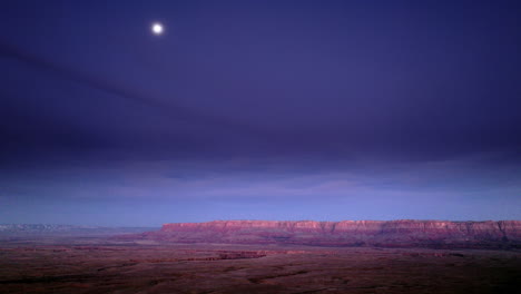 Drone-shot-of-dramatic-canyon-landscape-at-sunrise-with-moon