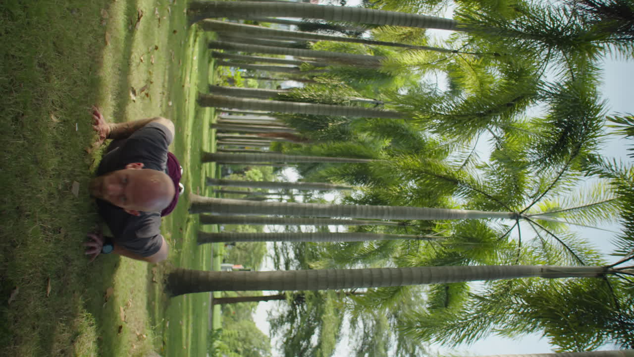 Man Doing Burpees with Resistance Band in Park
