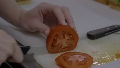 slicing fresh tomato for food preparation