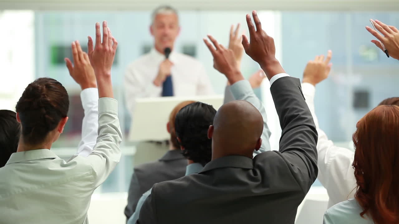 Business people raising their hands together