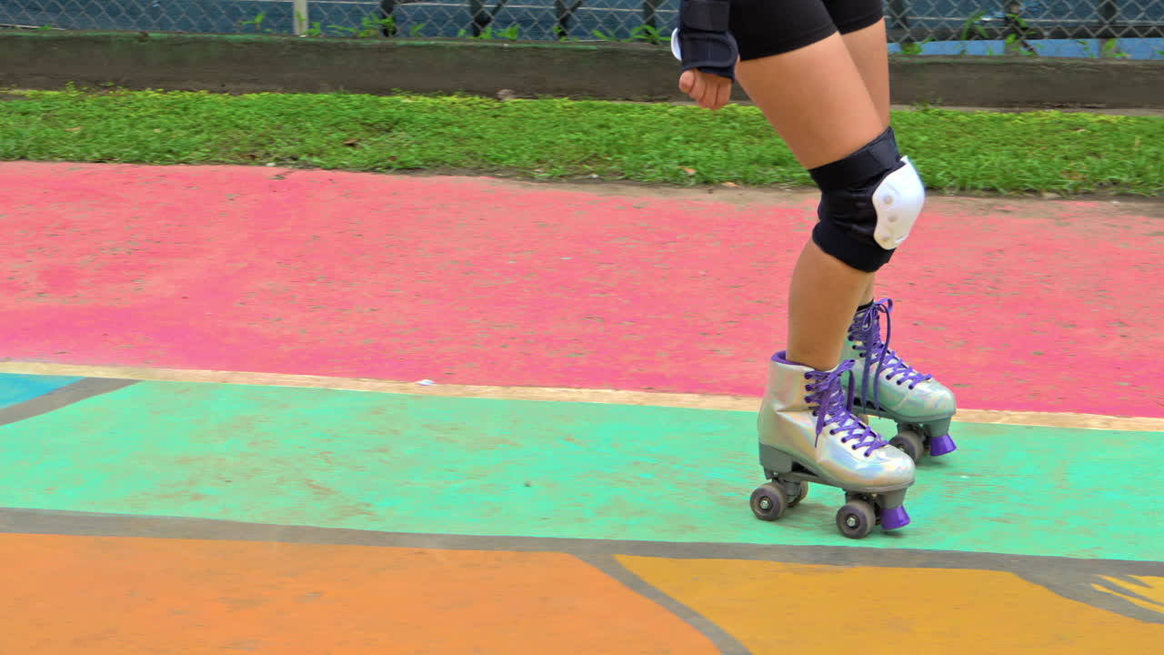 slow motion shot of a person learning to rollerskate at Harry Struntz Park