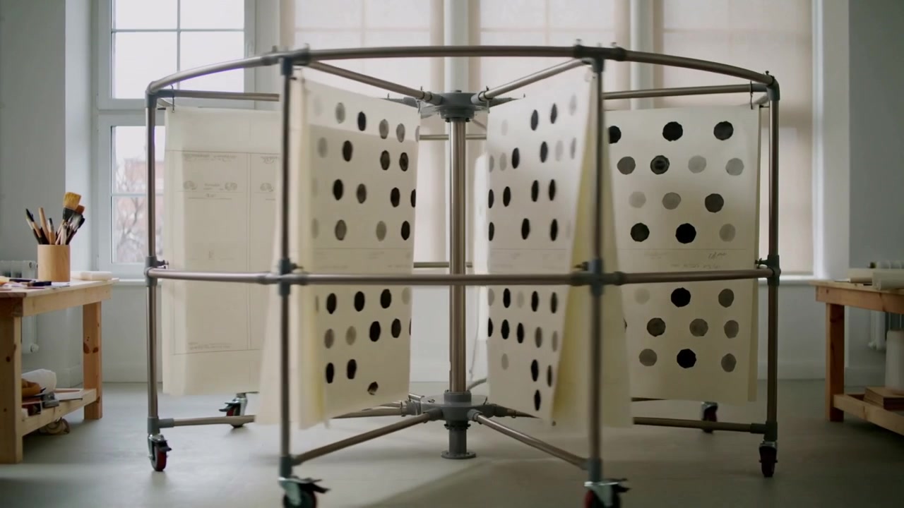 Rotating carousel at start, turning panels clockwise in art studio, showing dots to display art