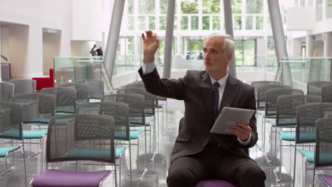 Businessman-In-Empty-Auditorium-Prepares-Speech-Shot-On-R3D