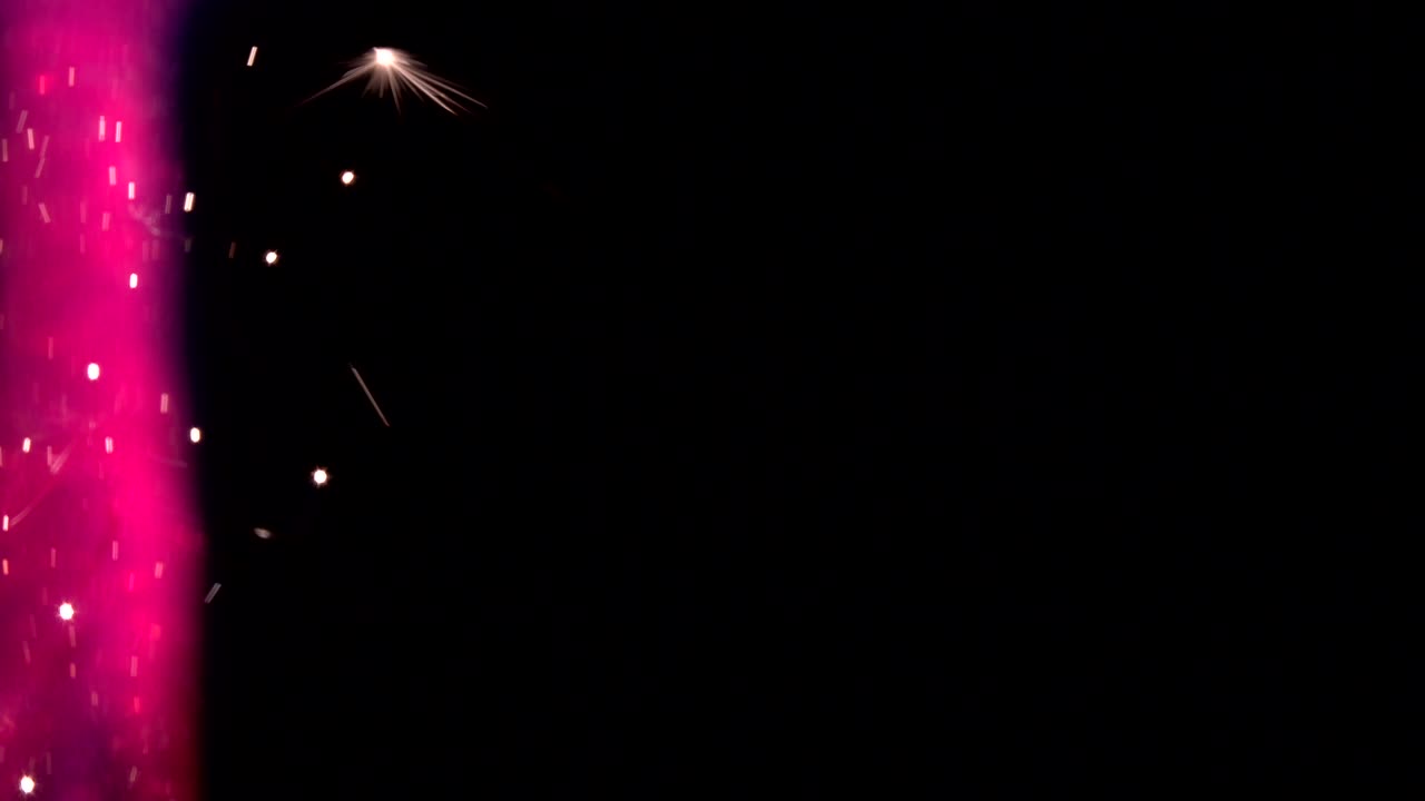 las chispas de fuego de color arco iris en un fondo oscuro. las chispas del fuego animación