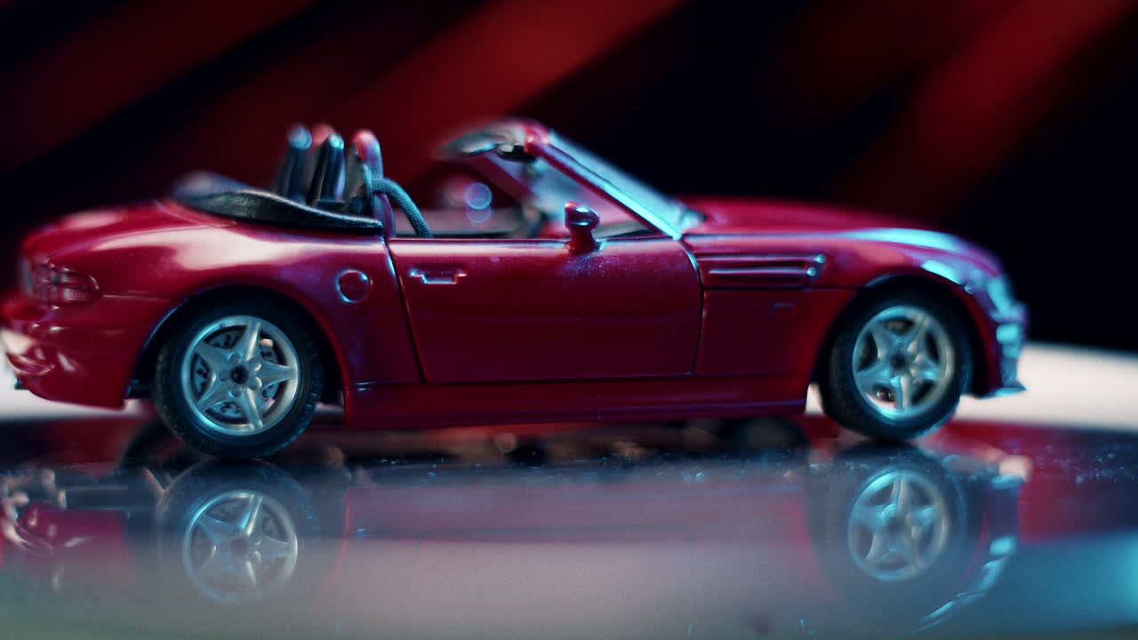 Red Toy Convertible Car with Reflection