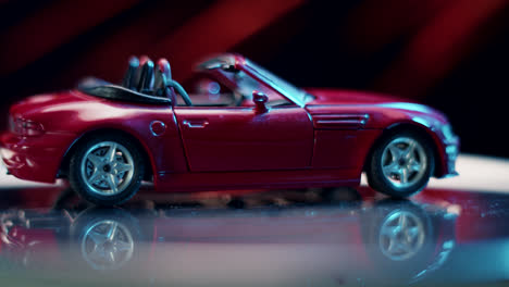 red toy convertible car with reflection