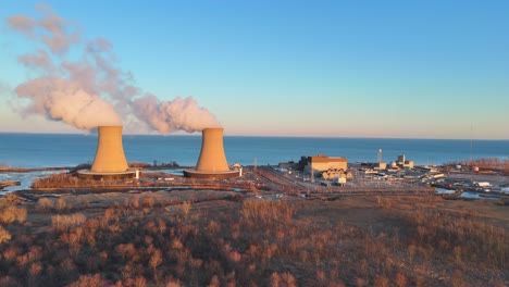 wide aerial of enrico fermi ii nuclear plant at dawn on lake erie coastline, berlin township, michigan, usa