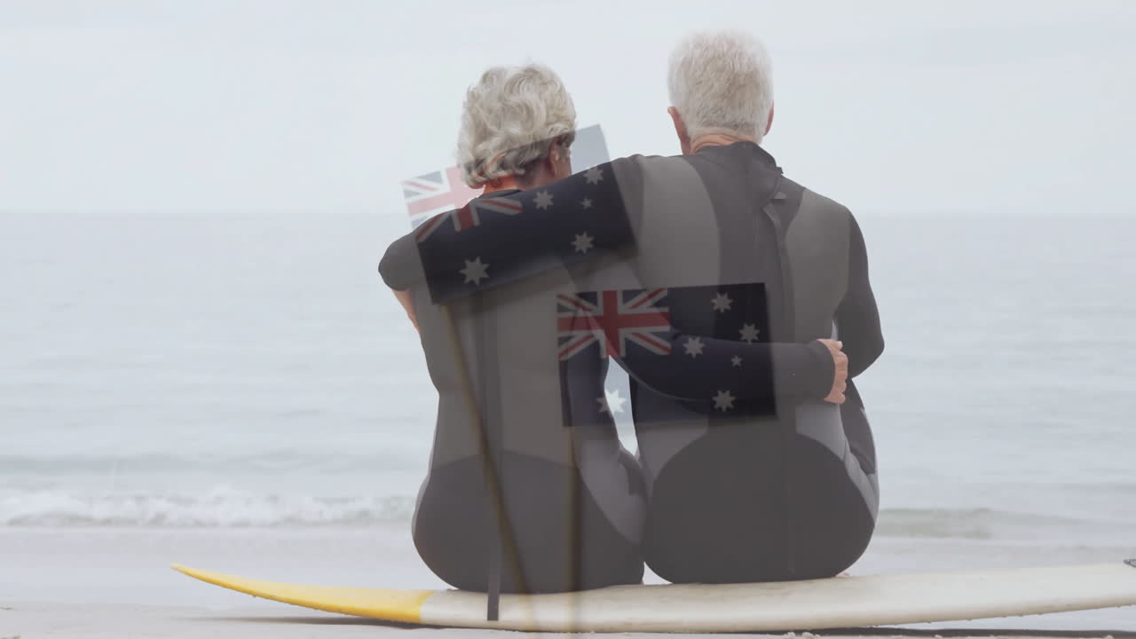 Sitting on surfboard by ocean, elderly couple with Australian flag animation