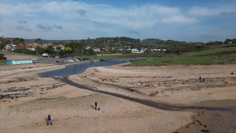 aerial-view-of-the-shoreline-in-the-south-of-England,-Dorset,-beach-and-tourists