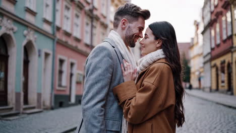 a romantic couple embracing on a cobblestone street