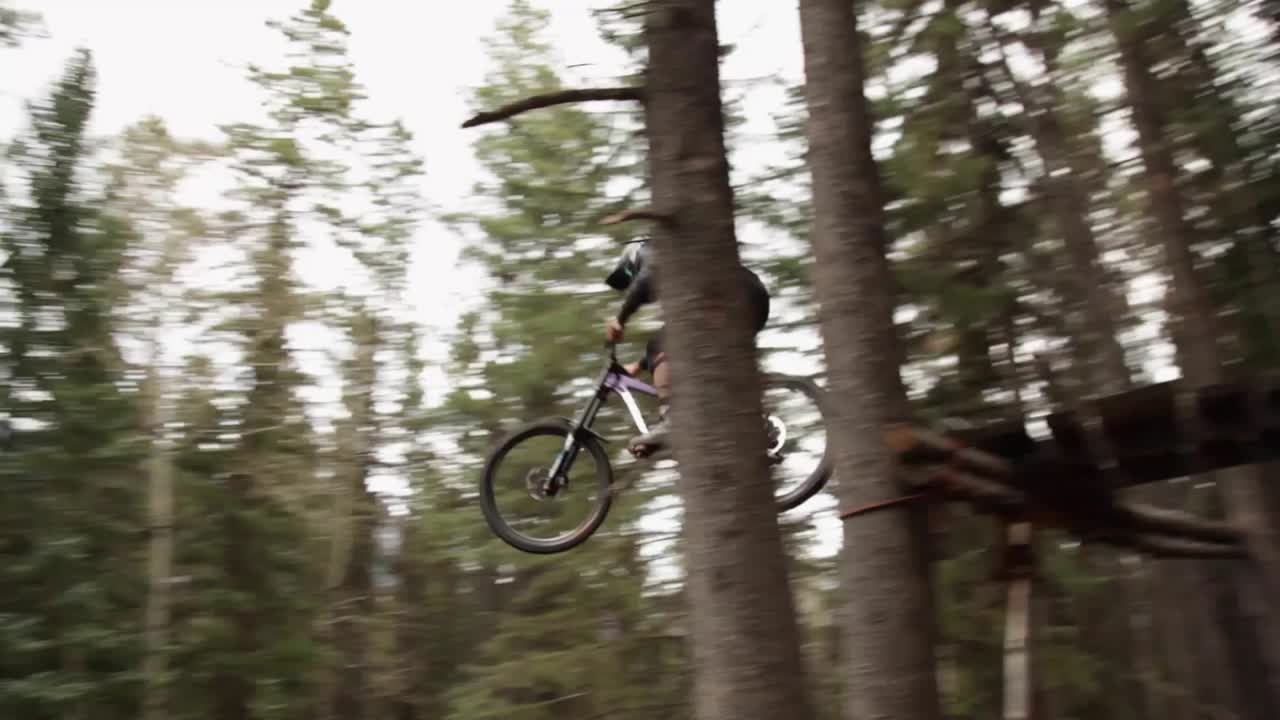 Biker jumps away from the camera pan