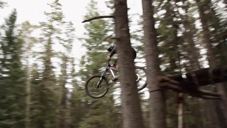 biker jumps away from the camera pan