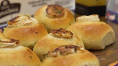 a delicious selection of freshly baked cream buns displayed on tray at bakery