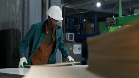 factory worker handling cardboard boxes