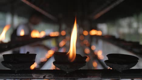 candles burning in buddhist temple