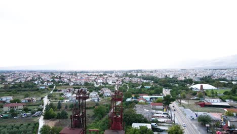 Aerial-drone-4k-clip-descending-over-a-chimney-and-an-industrial-area-in-the-area-of-Drama-in-Northern-Greece