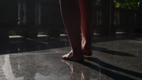 barefoot walking on stone path in a temple garden