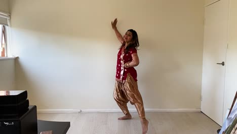 woman performing indian classical dance at home - wide