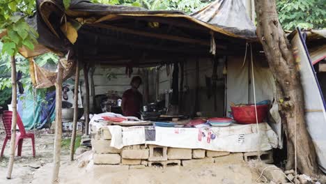 street food vendor cooking in a makeshift shack