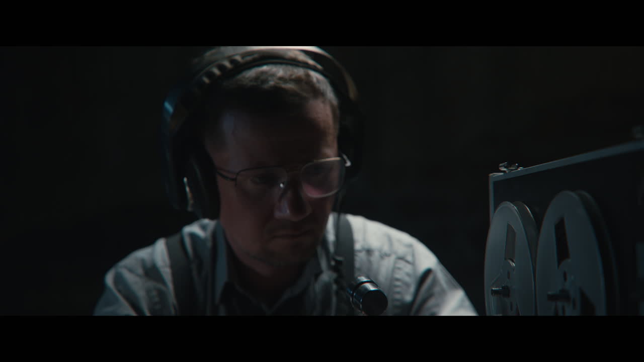 An intelligence officer listens to the wiretap recordings