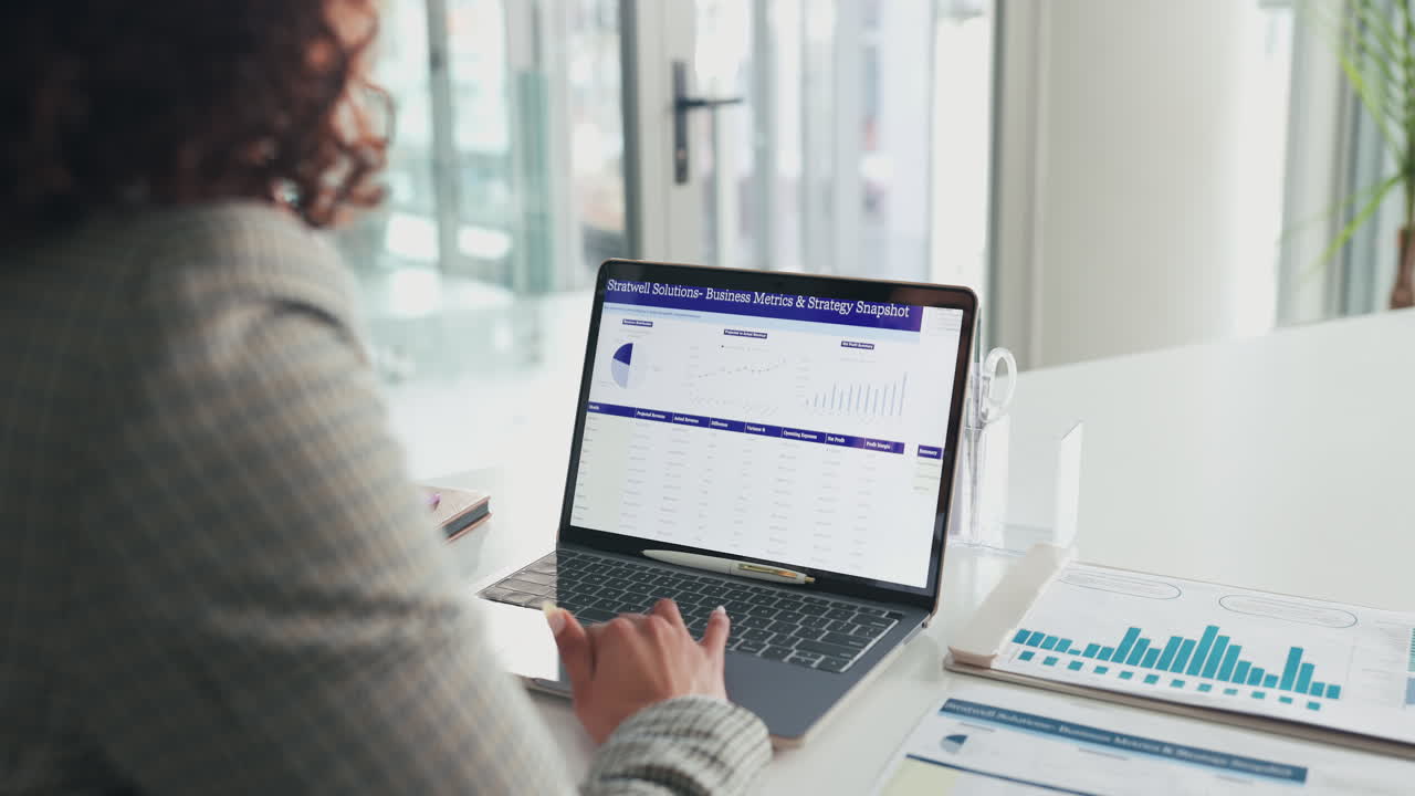 Business woman analyzing data on a laptop