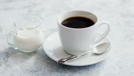 Cup-of-coffee-and-pitcher-of-milk