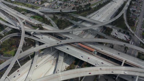 Slowly-Circling-Aerial-View-over-Judge-Pregerson-Interchange-Highway-showing-multiple-Roads-with-little-car-traffic-in-Los-Angeles-during-times-of-Coronavirus-Covid19-Pandemic-on-sunny-day