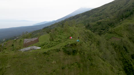 People-exploring-Bali-and-camping-a-top-green-ridge-in-Bali