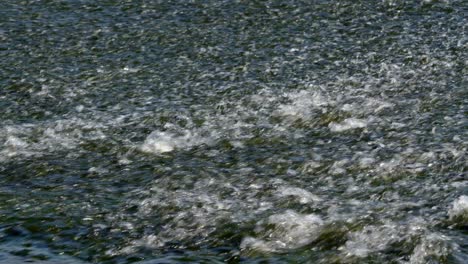 mid shot of water going over the river trent weir by by ratcliffe on soar power station
