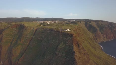 Vista-Aérea-De-La-Costa-En-Ponta-Do-Pargo-Y-Vista-Del-Faro,-Calheta,-Isla-De-Madeira,-Portugal