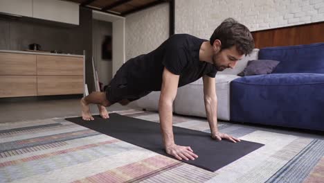 man holding hands on floor and doing push-up exercise