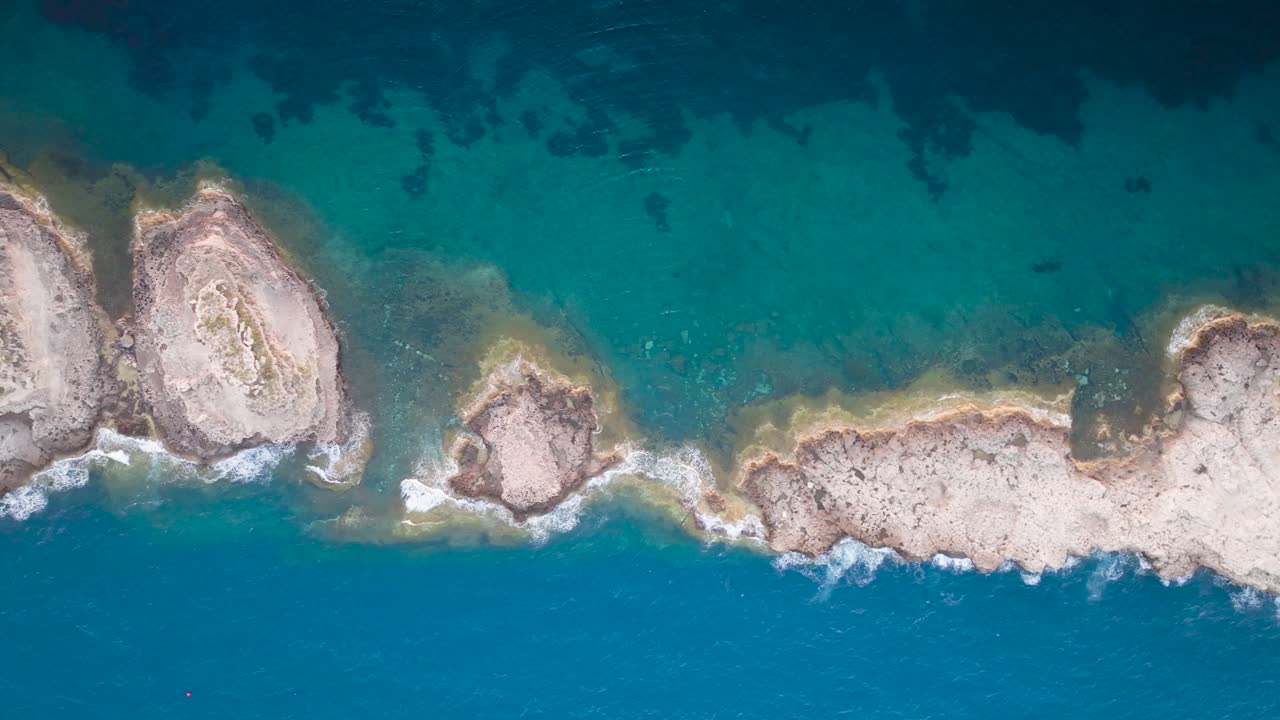 Aerial top down view of Punta de El Toro limestone path in sea, Mallorca