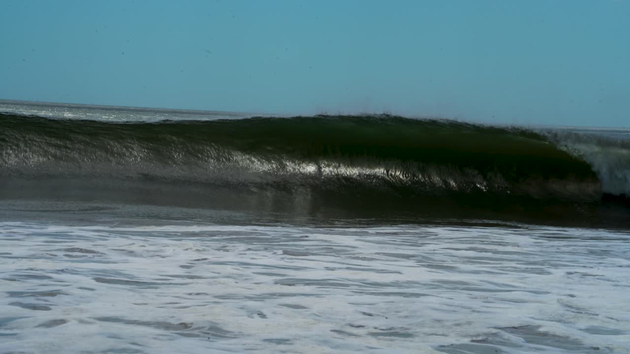 Wave crashing in ocean with offshore wind