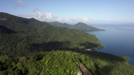 establishing drone shot of mountains and sea on the coast of costa verde, brazil